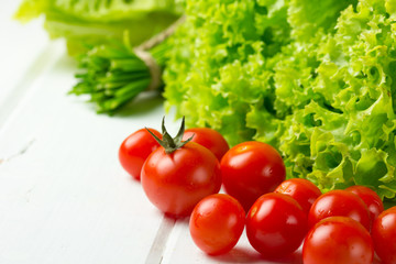 lettuce salad, tomatoes and green onion on white background