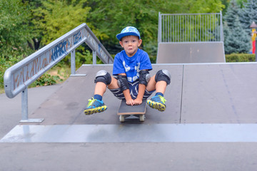 Excited little boy trying out his new skateboard