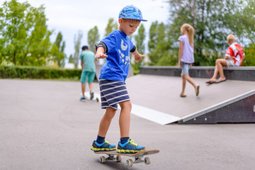 Little boy practicing on his skateboard