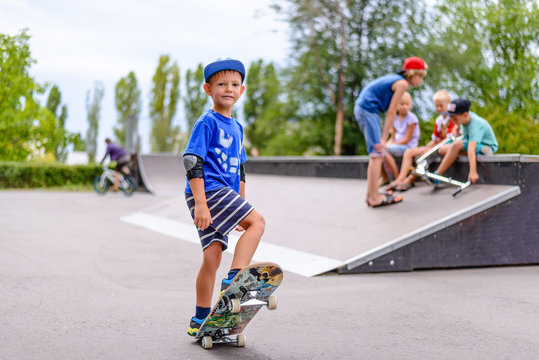 Young boy at a skate park with friends