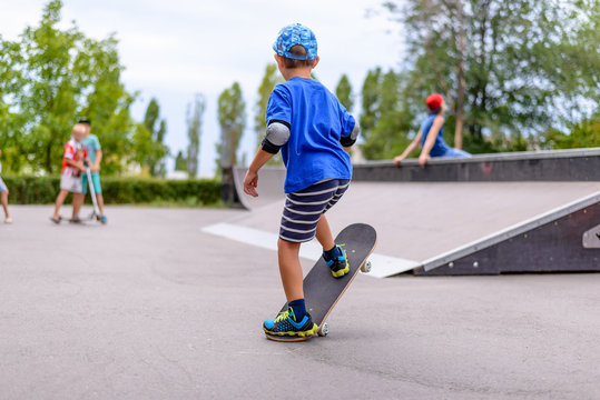 Little boy practicing on his skateboard