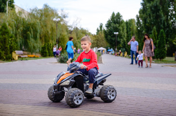 Little boy having fun on a quad bike