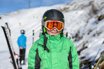 Fototapeta na wymiar Portrait of boy in helmet and ski goggles on a sunny day in the