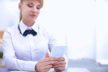 Woman in office using mobile phone