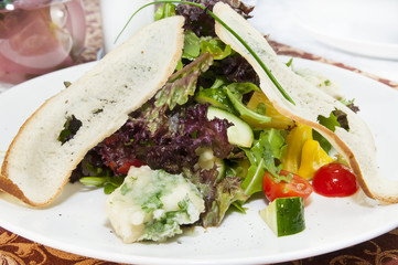 salad vegetables and goat cheese on a white background