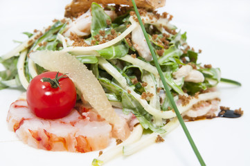 salad greens and shrimp meat on a white background