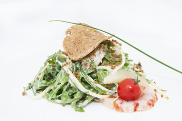 salad greens and shrimp meat on a white background