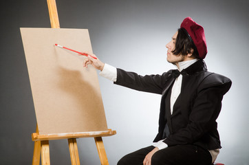 Funny artist in dark studio