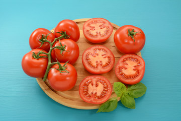 Tomatoes - cut, whole and on the vine with fresh basil