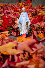 Virgin Mary in maple foliage