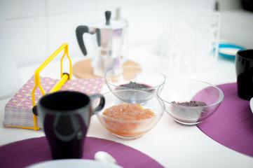 Breakfast set table close up, focus on marmalade bowls