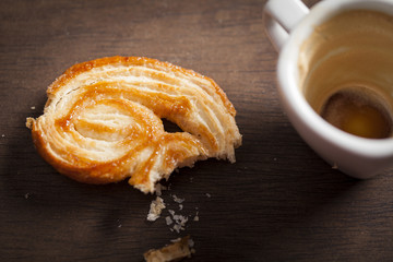 Palmiers sweet and empty coffee cup