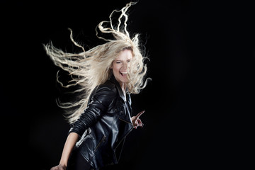 smiling young woman dancing, on a black background