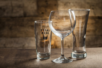 Different glasses on wooden background