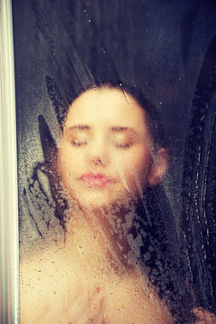 Woman standing at the shower.
