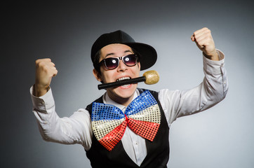 Funny man with mic in karaoke concept