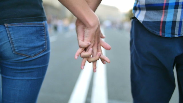 4 in 1 video! The couple (pair) walk and hold hands at the road in the city center. Slow motion capture.
