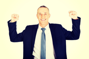Successful businessman with arms up