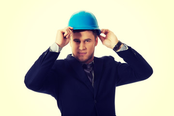 Happy businessman with blue hard hat.