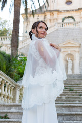 Fototapeta premium Beautiful bride outdoors posing on the steps