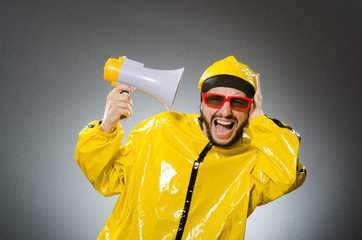 Man wearing yellow suit with loudspeaker