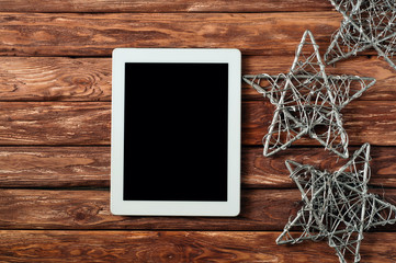 Tablet with blank screen on wooden background