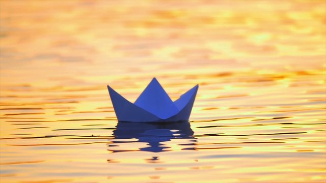 7 in 1 video! The man put paper boat by the bright sunlight reflection on the water surface background.