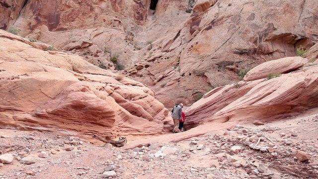 Friends hiking out of steep slot canyon desert HD 1613