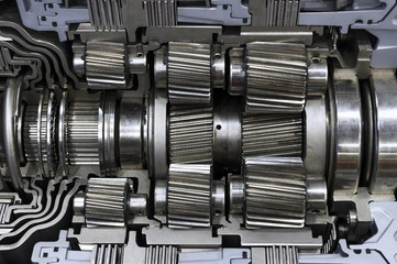 Gearbox cross-section, automotive transmission with sprocket and bearing mechanism for SUV, cargo, and construction vehicles, selective focus 