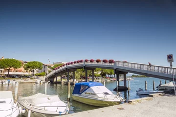 Acrylic prints City on the water Pedestrian bridge in Grado city center, Italy