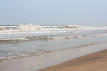Frothy waves on beach - Incoming high frothy sea waves on a tropical beach in the evening.