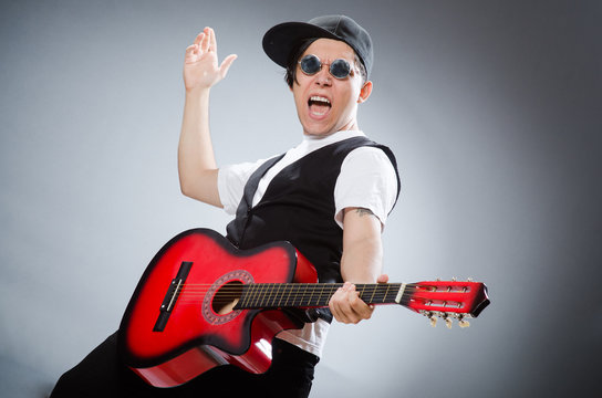 Funny guitar player in musical concept