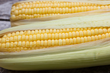 Fresh sweet corn on wooden table