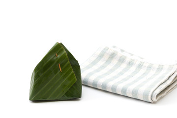 Thailand dessert wrapped in banana leaves isolated on white back