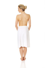 Young topless woman back after spa or bath.