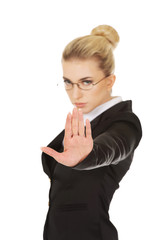 Young woman showing stop sign.