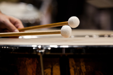Obraz na płótnie Canvas Drum sticks hitting the timpani closeup