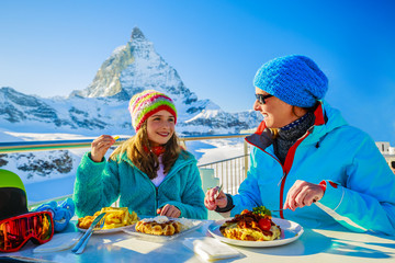 Winter, ski - skiers enjoying break for lunch