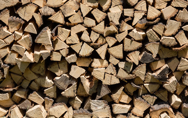 dry chopped firewood logs in a pile