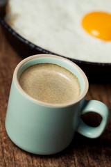 Breakfast setting with coffee and fried egg