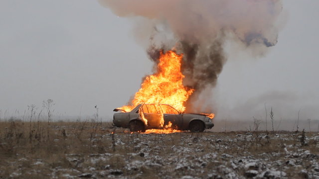 Car explosion on an empty field, side view