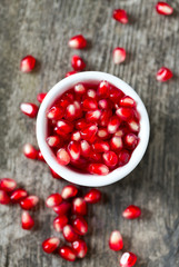 pomegranate seeds on wooden surface