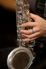 Fototapeta premium Hand girl playing the saxophone