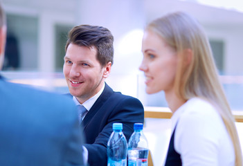 Group of happy young business people in a meeting at office