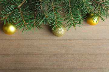 the branches and eating Christmas toy on a wooden background