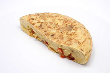 Spanish omelette with olive oil and red pepper isolated on white