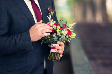 wedding bouquet in hands of the groom