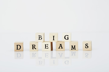 Tiles spelling 'Big dreams' in white studio