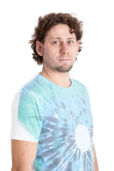 Curly haired Caucasian adult man in blue t-shirt standing and looking at camera, isolated on white background