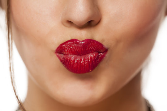 Fototapeta female pursed mouth with red lipstick